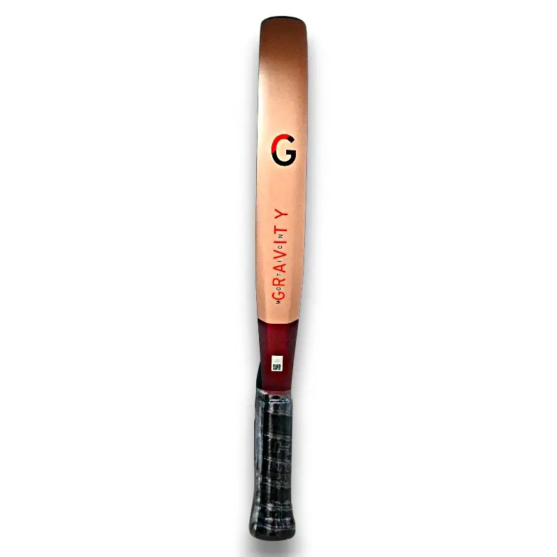 Vertical cricket bat with a copper-colored blade and dark wrapped handle, branded Gravity on a white background.
