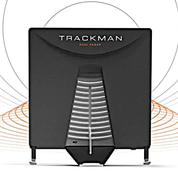 TrackMan Dual Radar launch monitor facing forward, a black rectangular unit with a central silver vent grille on a stand.