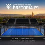 bae1515d-199d-4017-b3e6-12dee9786101 | Padel Magazine Padel court with blue glass walls and empty stands, branded Pretoria P1 tournament at Sunbet Arena, Time Square, sunset backdrop.