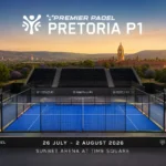 bae1515d-199d-4017-b3e6-12dee9786101 | Padel Magazine Padel court with blue glass walls and empty stands, branded Pretoria P1 tournament at Sunbet Arena, Time Square, sunset backdrop.