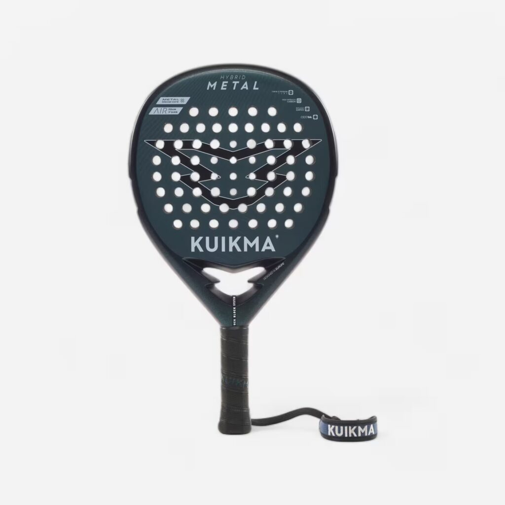 image | Padel Magazine Close-up of a Kuikma padel racket head, showing the string pattern, logo, and the KUIKMA branding with the handle visible downstream