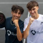 perrot huard de la marre | Padel Magazine Two young men on a padel court pose with fists up, holding rackets, wearing My Center Academy shirts and smiling at the camera.