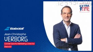Jean-Christophe Verborg, Global Sports Marketing Director, on a blue Babolat promotional banner with logo and text.
