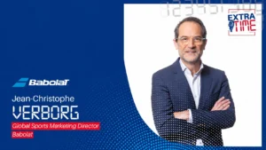 Jean-Christophe Verborg, Global Sports Marketing Director, on a blue Babolat promotional banner with logo and text.