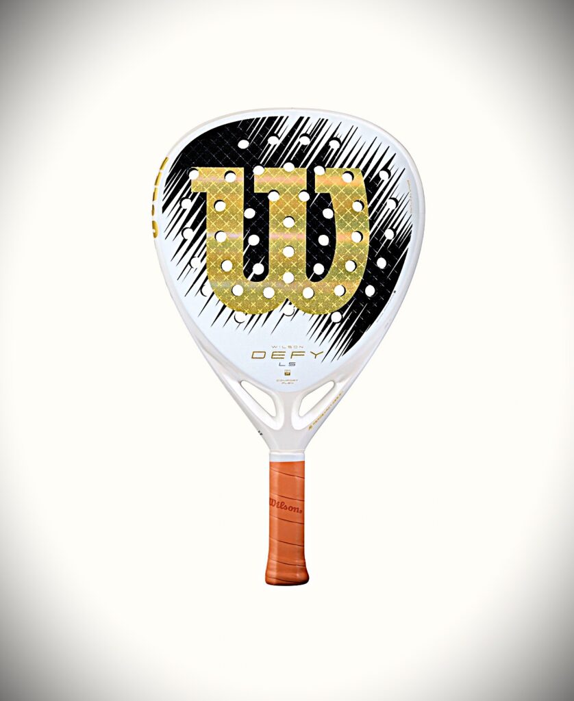 Padel racket with a black-and-white patterned face and a large gold '100' logo, orange grip, Wilson branding.