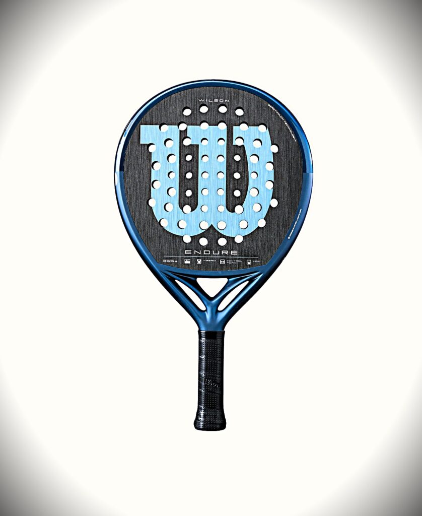 Blue Wilson Endure padel racket with a perforated face and textured grip on a light background